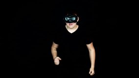 Teenager With VR Goggles Playing Virtual Video Game and Running in Place, Slow Motion
