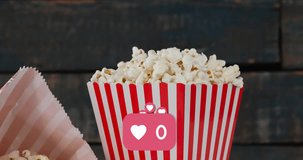 Animation of heart icons over boxes of popcorn. popcorn day and celebration concept digitally generated video.