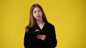 4k video of one girl taking notes over yellow background.