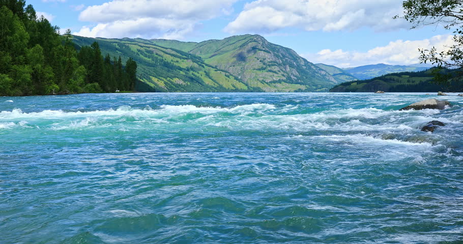Flowing river and forest with mountain natural landscape in Xinjiang, China.