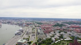 Inscription on video. Gothenburg, Sweden. Panorama of the city and the river Goeta Elv. The historical center of the city. Cloudy weather. Appears from the sand, Aerial View