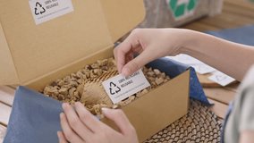 Eco vendor go green packaging parcel carton box in net zero waste store asian seller retail shop. Earth care day small SME owner asia people wrap reuse brown paper pack gift reduce plastic free order. - Powered by Shutterstock - Get 15% off with code: PIKWIZARD15