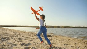 Happy laughing little girl runs along beach with toy airplane in her hand. Time for an active summer family vacation at sea. Girl play on ocean with an airplane. Child with beach toys. Happy child - Powered by Shutterstock - Get 15% off with code: PIKWIZARD15