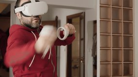 Man At Home Wearing Virtual Reality Headset Holding Gaming Controllers. Active VR Game Virtual Reality Technology Gaming Simulation Helmets. Person Fight Boxing AR Glasses. Technology