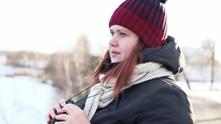 Young girl watching through binoculars