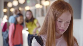 Students laughing and pointing to lonely sad girl standing aside. High school students bully upset teenage girl. Classmates laugh at teen schoolgirl. Realtime - Powered by Shutterstock - Get 15% off with code: PIKWIZARD15