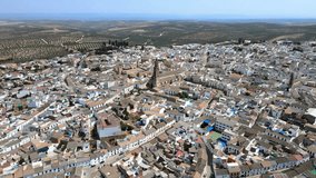 A camera drone flies forward over Bujalance, Andalusia, Spain