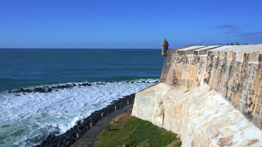 Fort wall sentry box above the Caribbean Sea crashing waves. Bartizan or garita at Castillo San Felipe del Morro, San Juan, Puerto Rico. Icon appears on Puerto Rican license plates and quarters. 