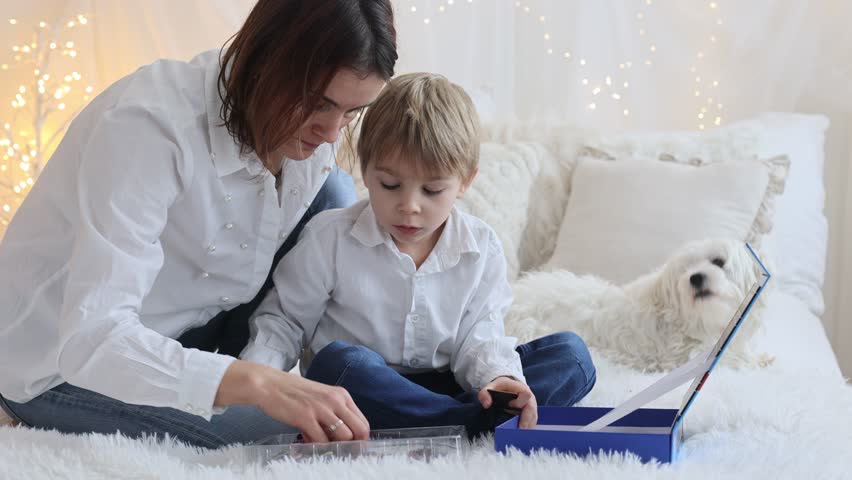 Cute little preschool child, playing with alphabet game, learning letters and words at home, preparing for school