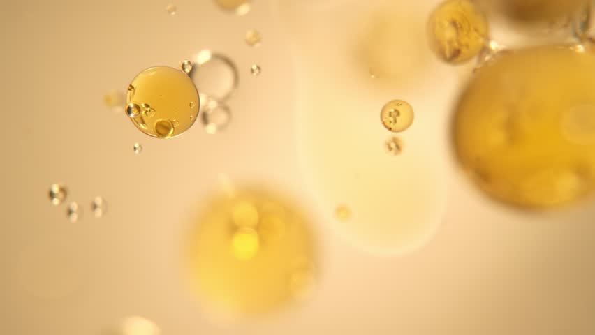 Super Slow Motion Shot of Oil Bubbles on Golden Background at 1000fps. Shoot on high speed cinema camera. Royalty-Free Stock Footage #1100834631
