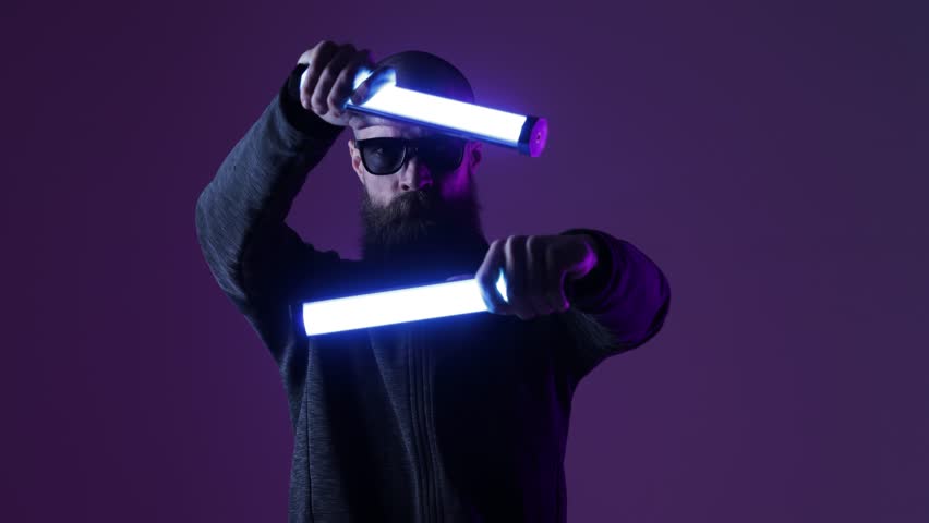 Man in futuristic costume. Guy in glasses of virtual reality while touching air. Augmented reality game, future technology, AI concept. VR. Neon blue light. Dark background.