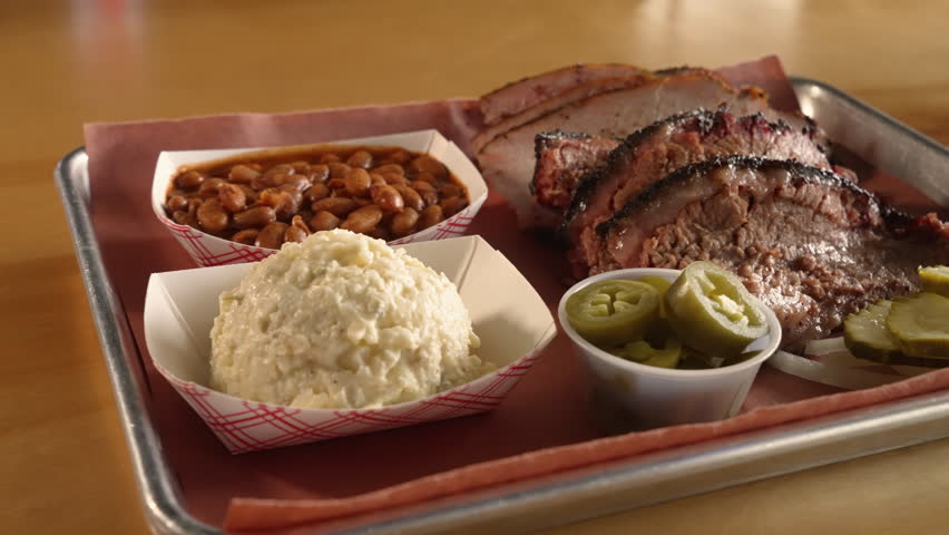 Smoked turkey and moist brisket fill tray of traditional Texas barbecue two meat plate, slider close up 4K