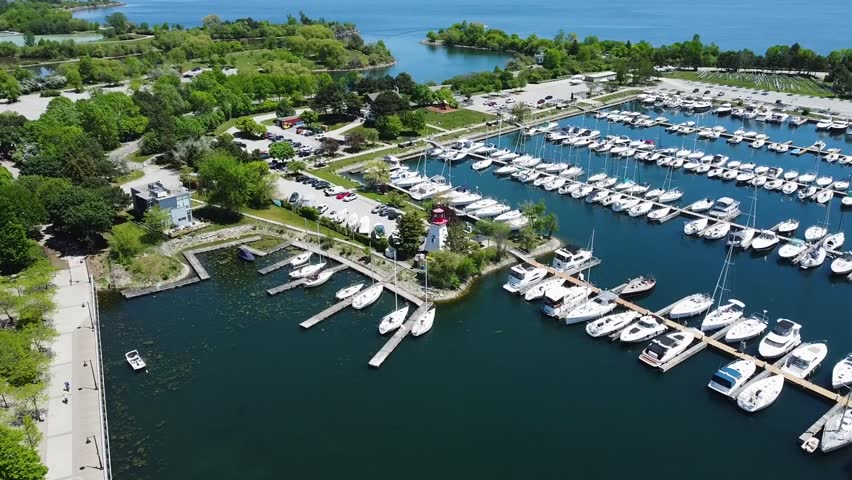 Aerial shot of a sunny Toronto harbor filled with boats on Lake Ontario.