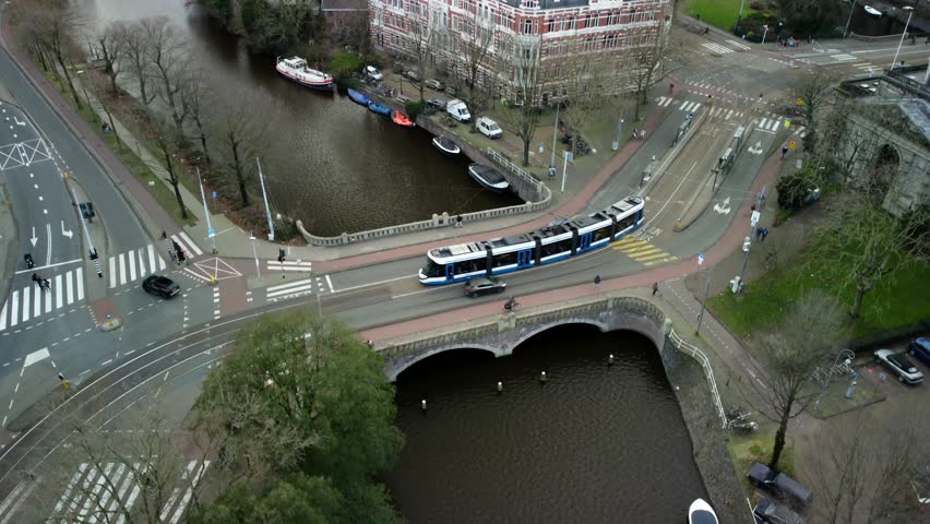 Modern Tram in Amsterdam, Netherlands 2023. Dutch Buildings, Canals, Bridges, Transport