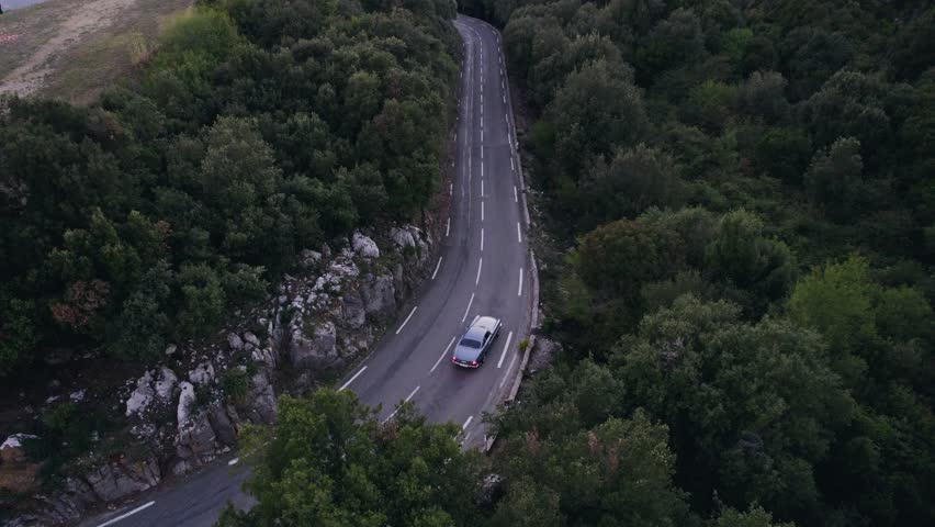 Old vintage car driving in the French mountains outside Monaco. Royalty-Free Stock Footage #1100844029