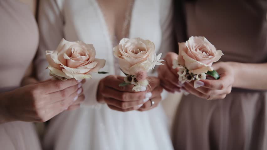 A bride and bridesmaids holding their bouquets. Morning preparing for meeting with a groom and his friends | Shutterstock HD Video #1100845467