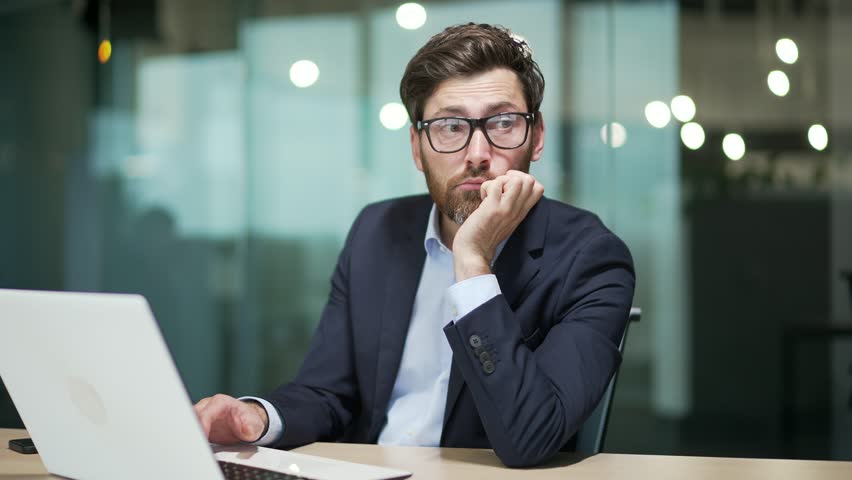 Bored business man in office Sleeping sleepy yawning boredom at workplace indoors Tired Exhausted Businessman entrepreneur in formal suit Portrait Depressed, unhappy, workless male manager workplace | Shutterstock HD Video #1100847293