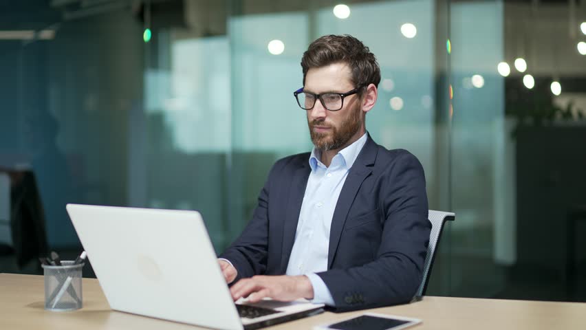 Resting entrepreneur investor with hands behind head feels satisfied with work well done indoor Calm bearded businessman relax after hard working day finished project job on computer at modern office Royalty-Free Stock Footage #1100847307
