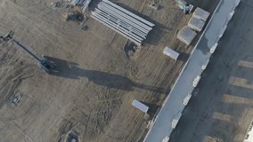 High above drone shot of crane plus material on construction site. - Powered by Shutterstock - Get 15% off with code: PIKWIZARD15