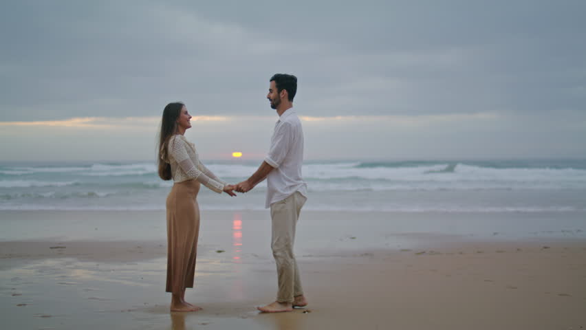 Amorous lovers engaging at sunset seashore. Handsome man making surprise marriage proposal to beloved woman at evening beach. Rejoicing girl saying yes. Emotional moment. Relationship goals concept Royalty-Free Stock Footage #1100853949