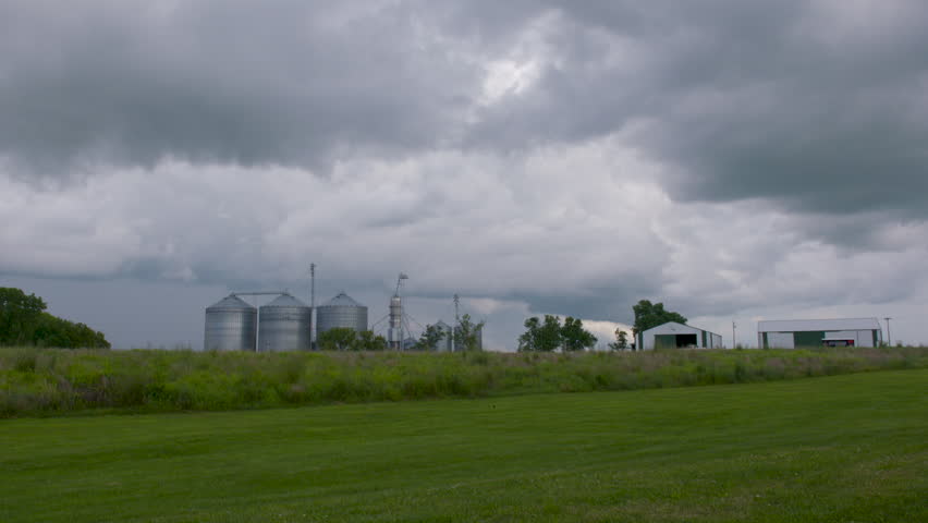 Timelapse of storm clouds rolling in over a farm in the Midwest USA