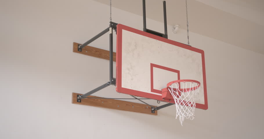 Wide Pan Right of a Basketball Going Into a Hoop in Slow Motion