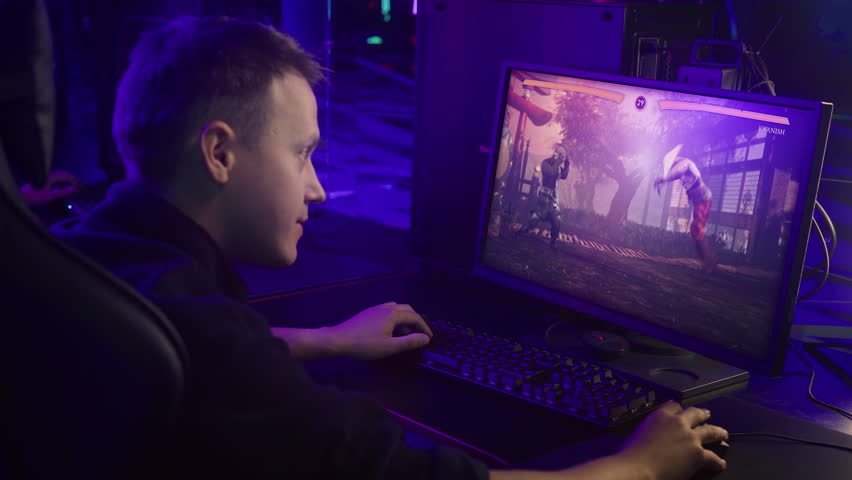 Player enjoying the newest versus fighting video game on a modern display. Playing the computer game on the wide display. Displaying the victory screen after the round of the computer game. | Shutterstock HD Video #1100861971
