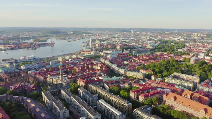 Inscription on video. Gothenburg, Sweden. Panorama of the city and the river Goeta Elv with ships. Sunset. On the mechanical display, Aerial View