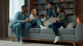Group ethnic people friends talking discussing future plans at home meeting diverse multiracial women and men sit on comfortable sofa chatting friendly communication spending weekend together at home - Powered by Shutterstock - Get 15% off with code: PIKWIZARD15