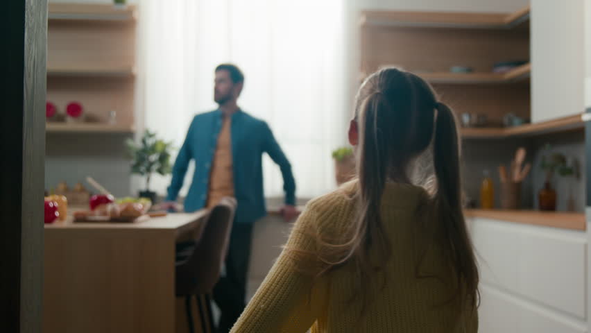 Pensive man standing at kitchen little daughter kid run to dad running to father daddy rise up baby spinning lovely child spin girl around swirling hugging cuddling. Caucasian family bonding at home Royalty-Free Stock Footage #1100866837
