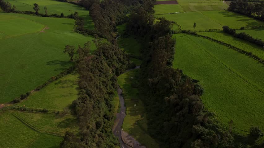 Slow aerial landscape shot of the San Pedro river bed, Machachi, Ecuador.