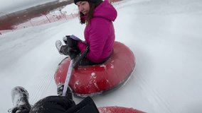Winter slide, family time, funny girl Video in the first person. Winter outdoor activities. Selective focus