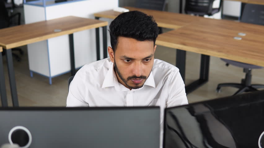 Indian trader broker checking stock trading data analysis concept working in office with financial graph | Shutterstock HD Video #1100871623