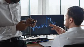 Diverse managers traders analysts discussing financial growth market at desk with pc graphs on screen - Powered by Shutterstock - Get 15% off with code: PIKWIZARD15