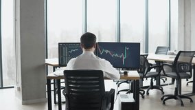 Back view of trader is working with multiple computer screens full of charts and data analysis and stock broker trading online. Concept of bitcoin and stock market trading - Powered by Shutterstock - Get 15% off with code: PIKWIZARD15