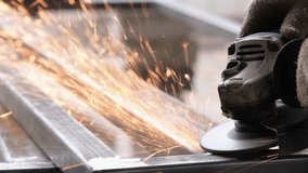 A man working with electric grinder tool on Steel beam. sparks flying. Electric grinding. Remove rust - Powered by Shutterstock - Get 15% off with code: PIKWIZARD15