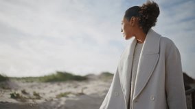 Girl hand stroking railings on beach. Pensive girl walking pier looking solution making decision. Thoughtful african american admiring autumn seashore resting alone on weekend. Lonely female concept. - Powered by Shutterstock - Get 15% off with code: PIKWIZARD15