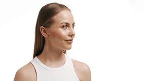 Fit attractive european blonde skin care woman touching her bare shoulder and turning her head to the camera looking at it and smiling broadly against a white background. - Powered by Shutterstock - Get 15% off with code: PIKWIZARD15
