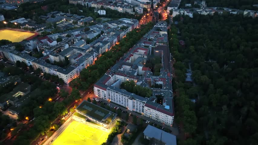 Birds Eye View over Berlin, Germany Neighborhood at night with glowing street traffic city lights