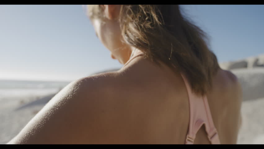 Headphones, start or woman at a beach for fitness training, running exercise or cardio workout in Australia in summer. Focus, podcast or girl runner ready for exercising and streaming music or radio Royalty-Free Stock Footage #1100877667