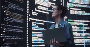Portrait of Young Woman Working on Laptop Computer, Looking at Big Digital Screen Displaying Back-end Code Lines. Professional Programmer Developing a Big Data Interface Software Project - Powered by Shutterstock - Get 15% off with code: PIKWIZARD15