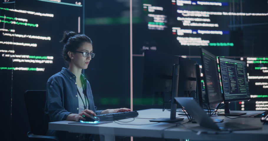 Portrait of Two Colleagues Working in a Monitoring Room, Surrounded by Big Screens Displaying Lines of Programming Language Code. Professional Hackers Breaking Through Cybersecurity Protection System Royalty-Free Stock Footage #1100883639