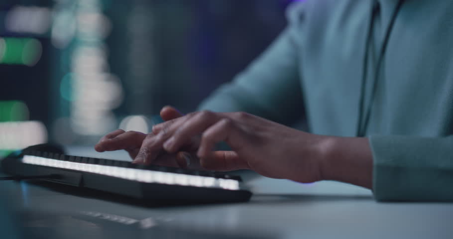 Black Male Developer Smiling Happily After Successfully Typing on Computer a Functioning Software Code. Tracking Shot from Hand to Face of Professional Programmer Collaborating Online with Colleagues | Shutterstock HD Video #1100883671