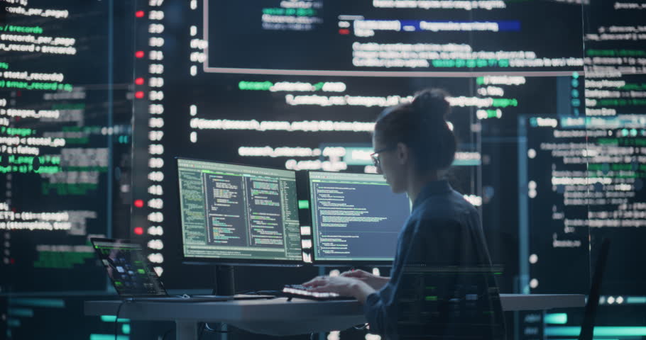 Female Developer Thinking and Typing on Computer, Surrounded by Big Screens Showing Coding Language. Professional Programmer Working in a Modern Office, Running Coding Tests. Futuristic Programming Royalty-Free Stock Footage #1100883687