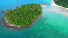 Experience an exhilarating from a drone as it flying over a stunning sandbar, connecting the mainland to an enchanting island in the midst of a tropical paradise. (Krabi Province, Southern Thailand)
