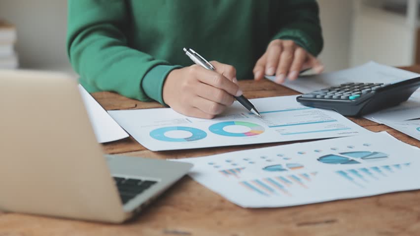 Financial Businesswomen analyze the graph of the company's performance to create profits and growth, Market research reports and income statistics, Financial and Accounting concept. | Shutterstock HD Video #1100884085