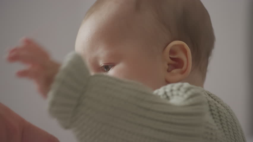 Close up toddler son baby holding grandmother hand in slow motion