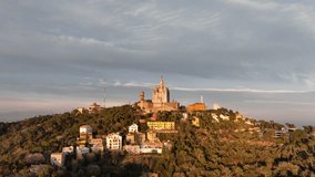 Church on summit of Mount Tibidabo in Barcelona, Catalonia, Spain. Aerial forward ascending and sky for copy space
