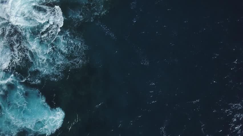 gorgeous waves crashing on spitting cave in honolulu hawaii with fancy homes and greenery - AERIAL DOLLY TILT REVEAL