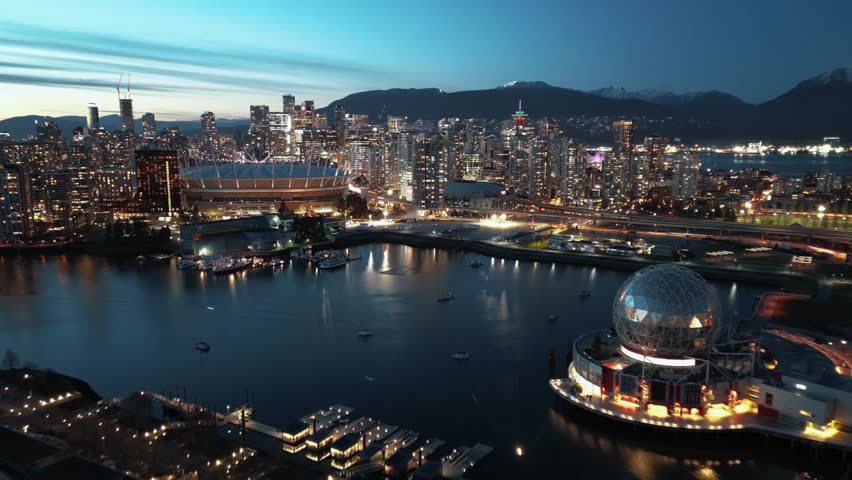 Aerial hyperlapse of night cityline with skyscrapers. Vancouver, Canada.